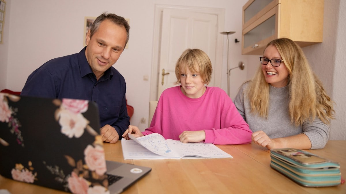 Parents and daugther learning together.